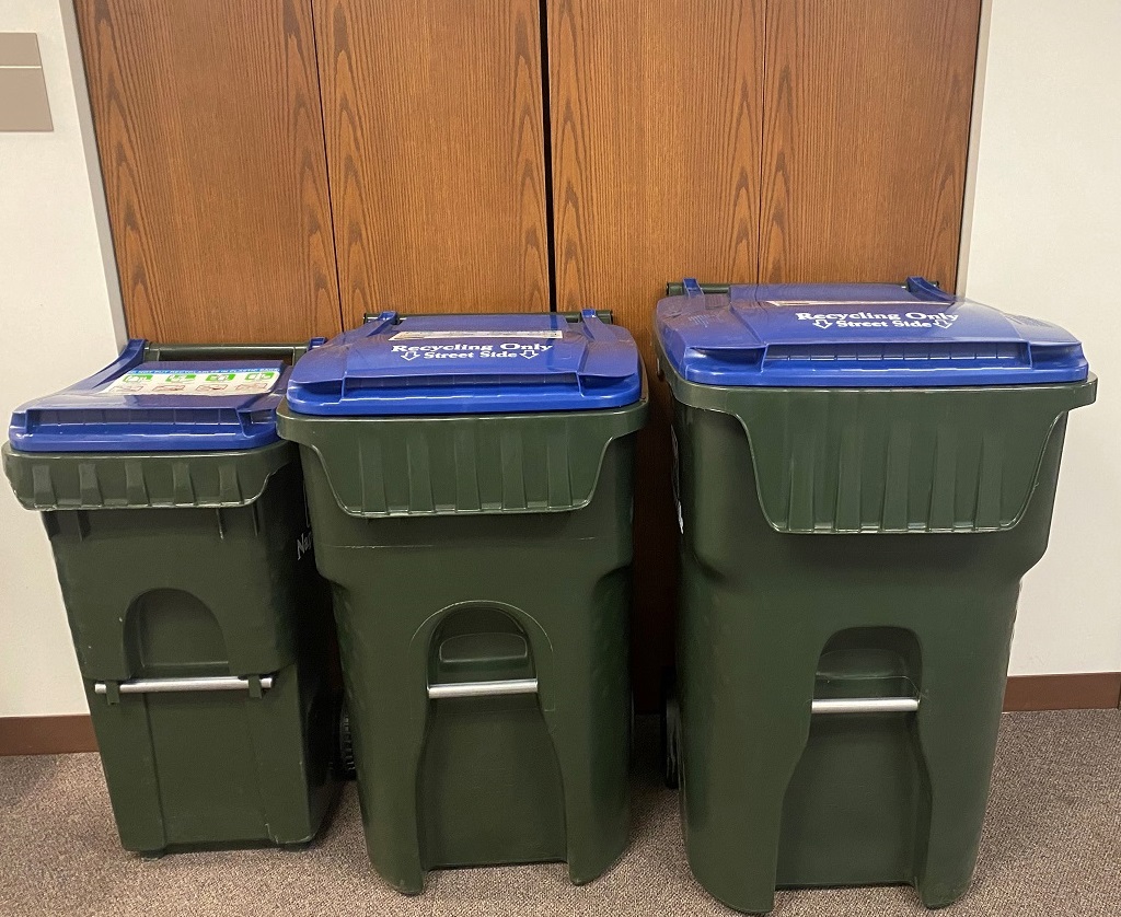 three recycling carts of different sizes stand next to each other for scale