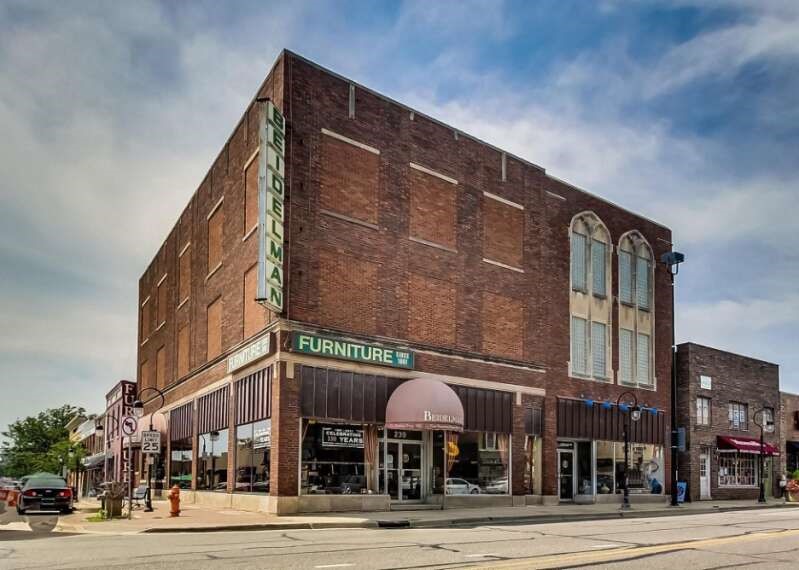 three story brick building on corner of street