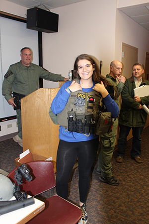 A Citizen Police Academy participant dons a vest used by NPD's Special Response Team