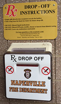 a wall-mounted prescription drug drop box on a Naperville fire station