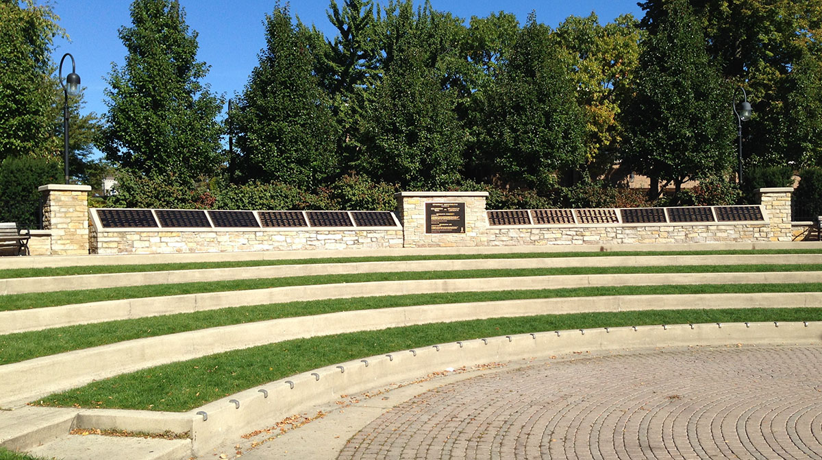 Grass-covered stairs lead to a wall where names of donors to Millennium 2000 are inscribed on bronze panels.