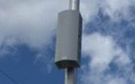 a close up of small cell equipment mounted on a light pole