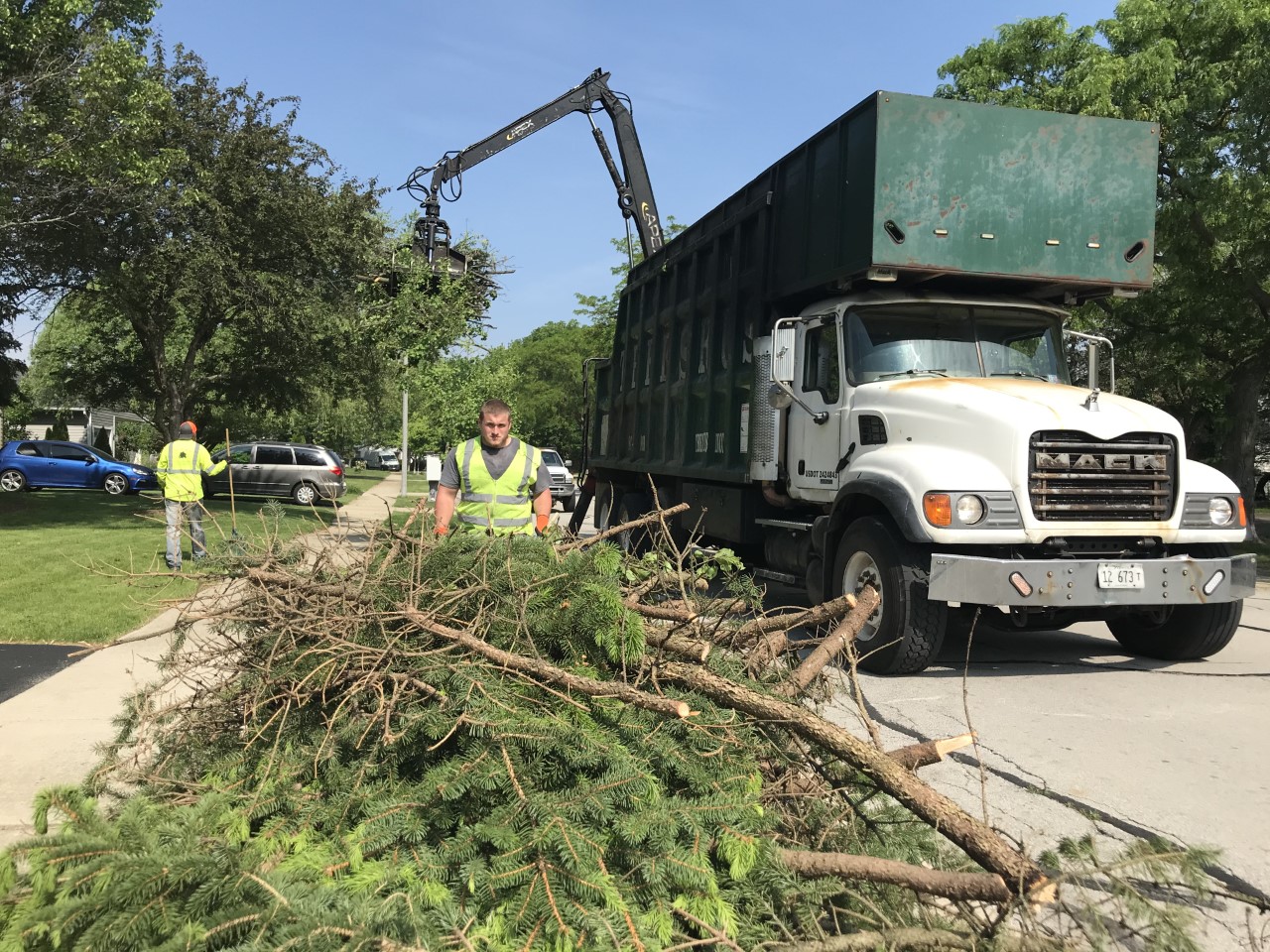 City workers collect evergreen branches during the annual spring bulk brush collection.