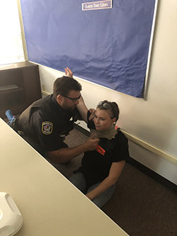 An intern participates in training with an officer